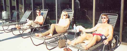 The owners Dennis and Sara and Agent Mike Brady relax by the pool